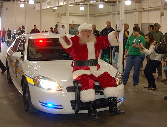 Photos by Max Marbut - Santa Claus arrived on a police car at the Fraternal Order of Police Lodge 5-30's annual Christmas party for special needs children.