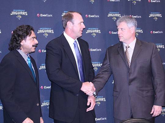 Photo by Joe Wilhelm Jr. - Jaguars owner Shahid Khan (left), introduced new Jaguars head coach Mike Mularkey at a news conference Wednesday as General Manager Gene Smith shakes hands with the new coach.