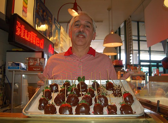 Photos by Max Marbut - Doug Ganson, owner of Sundrez at the Landing, is dipping fresh strawberries in chocolate. They're available every day through Valentine's Day and he's taking advance orders for pickup next week.