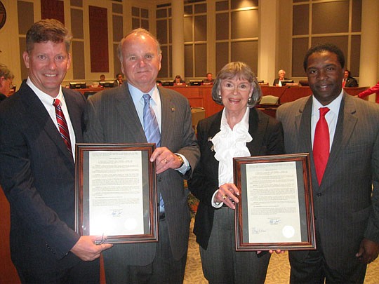 Photo by David Chapman - Former Jacksonville Jaguars owners Wayne and Delores Barr Weaver (middle) were honored Tuesday by the City Council for their contributions to the community. Council President Stephen Joost (left) read the resolution and offere...