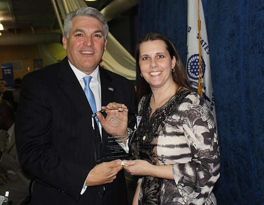 Photos by Joe Wilhelm Jr. - Jacksonville Port Authority CEO Paul Anderson accepts a token of thanks from Propeller Club of Jacksonville President Melissa Wilson for his presentation on the "State of the Port" at the club's Thursday meeting at the port...