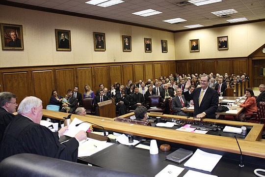 Photos by Joe Wilhelm Jr. - Fourth Circuit Chief Judge Donald Moran swears in new Circuit Judge Tyrie W. Boyer on Thursday at the Duval County Courthouse. Gov. Rick Scott appointed Boyer to fill the vacancy created by the retirement of Judge Haldane T...