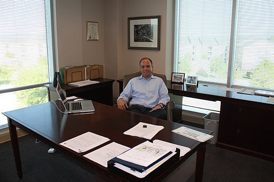 Photos by Joe Wilhelm Jr. - Ashton Hudson is president and general counsel for Rock Creek Capital and describes the dÃ©cor of his Southside office as "boring."