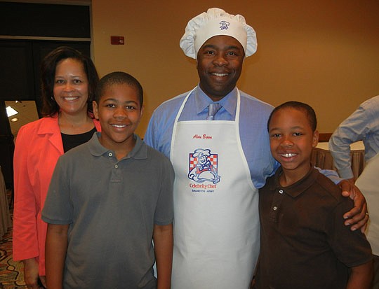 Photos by Karen Brune Mathis - Mayor Alvin Brown donned his chef's hat and apron for a photo before the 26th Annual Celebrity Chefs Tasting and Silent Auction Thursday at the Osborn Center. He was joined by his wife, Santhea, and sons Joshua and Jordan.