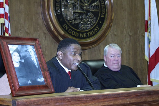 Photos by Joe Wilhelm Jr. - New Duval County Court Judge Mose Floyd (left) thanked his parents (in photo) Thursday at his investiture for giving him the tools to take advantage of an opportunity to become a judge in the Fourth Judicial Circuit. Floyd ...
