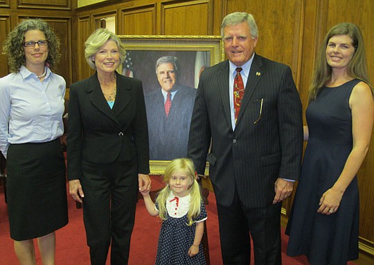 Photo by David Chapman - Circuit Court Judge Haldane Taylor celebrated his career Thursday in a retirement ceremony and portrait unveiling at the Duval County Courthouse. He was joined by daughters Kelly Rousseau (left) and Holly Cauley (right), his w...