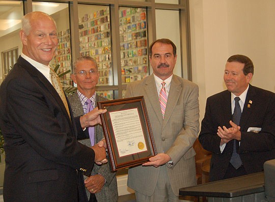 Photos by Max Marbut - From left, Jim Selzer, chairman of the board of library trustees, and City Council members Doyle Carter, John Crescimbeni and Jim Love were at the Main Library Tuesday to recognize the contributions the public libraries make in ...