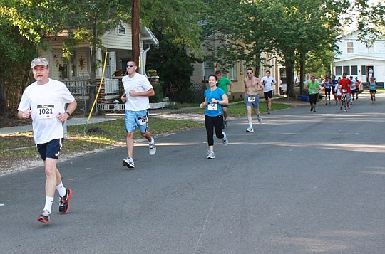 Photos by Joe Wilhelm Jr. - Mark Alexander, a partner with Alexander DeGance Barnett, leads a pack through Riverside on his way to Willow Branch Park.