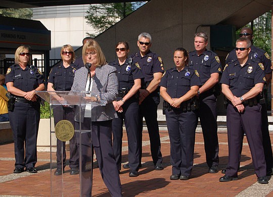 Photo by Max Marbut - Women's Center of Jacksonville Executive Director Shirley Webb (at podium) hosted a gathering April 12 at Hemming Plaza in recognition of April being proclaimed "Sexual Assault Awareness Month." According to the Florida Council A...