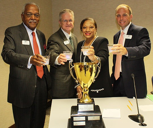 Photo by Joe Wilhelm Jr. - JEA board of directors member Ron Townsend, JEA Managing Director and CEO Jim Dickenson, board Secretary Cynthia Austin and board Chair Ashton Hudson celebrate Tuesday. JEA was recognized for having the best-tasting drinking...