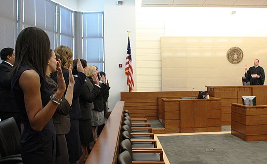 Photos by Joe Wilhelm Jr. - The local celebration of Law Day 2012 included the swearing-in of new attorneys at the Bryan Simpson U.S. Courthouse April 26. Corrigan administered the oath to 17 new attorneys.