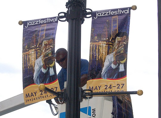 Photo by Max Marbut - 2012 Jacksonville Jazz Festival banners were being installed Wednesday on the historic light poles along Laura Street.