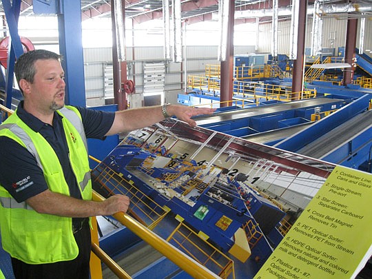 Photos by David Chapman - Jeremy Dixon, Republic Services maintenance manager, provides a tour of the new 70,000-square-foot recycling facility in Northwest Jacksonville. About 120 tons of recycled material - even those with food and drink particles -...