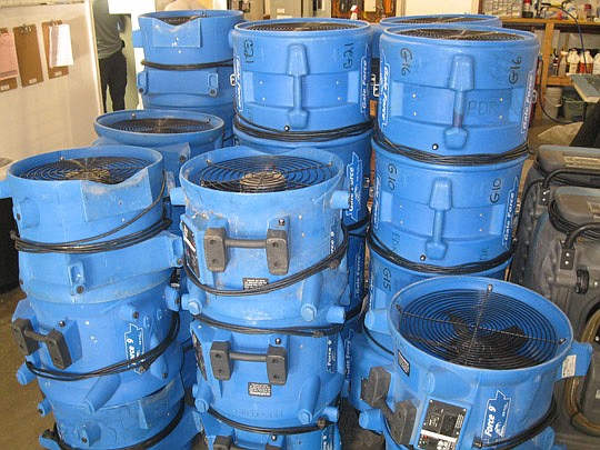 Photo by David Chapman - These quick-dry fans used to dry parts of water-soaked residences weren't in the warehouse long. Crews heading out Wednesday morning quickly snatched them for what has turned into a long week due to storms over the weekend.