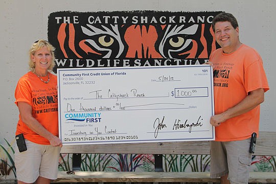 Kim Kyle, assistant director for the Catty Shack Ranch, and Curt LoGiudice, executive director and curator, accepted a $1,000 grant from Community First Credit Union's Investing in You contest to support the organization's big cat rescue work and educ...