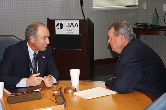 Photo by Joe Wilhelm Jr. - From left, Steve Grossman, Jacksonville Aviation Authority CEO and executive director, and Ron Weaver, secretary of the JAA board of directors, talk Monday during a board meeting at the authority's administration building.