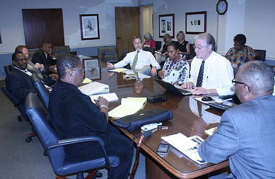 Photo by Joe Wilhelm Jr. - Seated clockwise from left, City Council members Denise Lee, Johnny Gaffney, DonÂ Redman, Reggie Brown, incoming Council President Bill Bishop, Kimberly Daniels, Lee's executive assistant Dan Macdonald and Warren Jones met T...