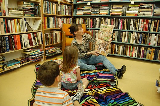 Photo by Max Marbut - Jennifer O'Donnell, manager of Chamblin's Uptown, reads to children in the bookstore each Tuesday.