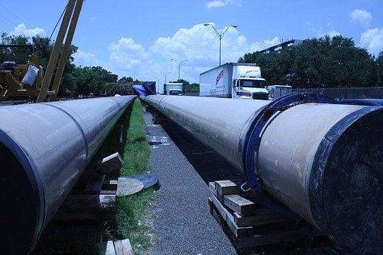 Photo by Joe Wilhelm Jr. - Prior to installation under the St. Johns River, the 6,700-foot-long section of pipeline will be assembled along the south shoulder of the Arlington Expressway. The total length of pipe for the project is 8.3 miles.