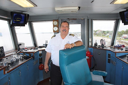 Photo by Joe Wilhelm Jr. - St. Johns River Ferry Capt. Wayne Fenner, in the "wheel house" of the Jean Ribault, has transported passengers across the St. Johns River to Mayport Village and Fort George Island since 1995. Fenner is a Coast Guard veteran ...