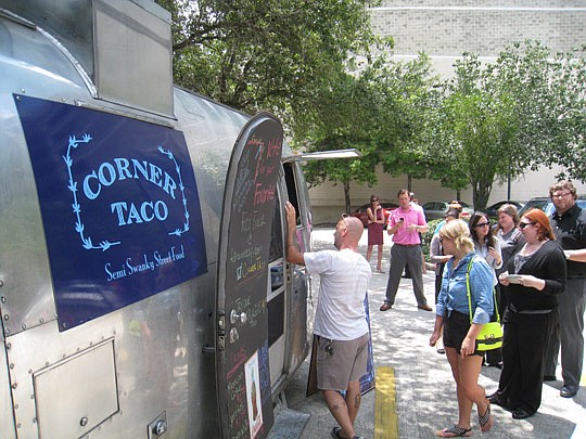 Photo by David Chapman - Corner Taco is one of the food trucks in the daily rotation on Mondays to set up shop at the southwest corner of Forsyth and Main streets Downtown. The food trucks use a space within a City-owned lot and establish their own hours.