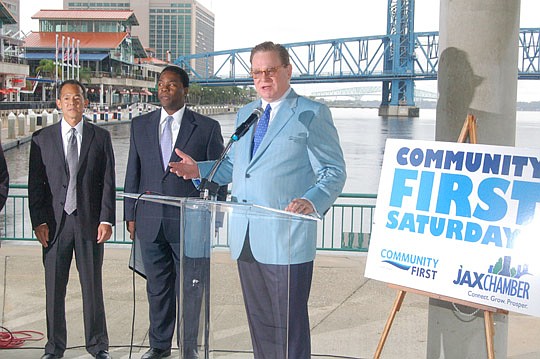 Photo by Max Marbut - JAX Chamber President Wally Lee (at podium) helps introduce "Community First Saturdays," a new program aimed at making Downtown more vibrant. He is joined by Community First Credit Union President and CEO John Hirabayashi and May...