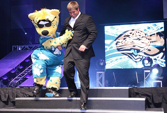 Photos by Joe Wilhelm Jr. - Jaguars mascot Jaxson de Ville helps Jaguars center Brad Meester down the stairs. Meester is the longest tenured Jaguar, having played his entire career, 177 games, in Jacksonville.