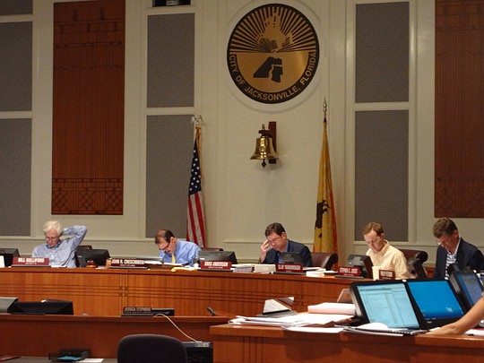 Photo by David Chapman - Members of the City Council Finance Committee look through auditor recommendations Thursday as they make adjustments to balance the City's budget.
