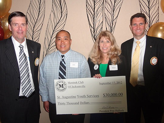 Photo by David Chapman - During its Monday meeting, the Meninak Club of Jacksonville presented its 2012 Charity Grant award to St. Augustine Youth Services. The grant is awarded annually to a youth-serving nonprofit to apply toward a capital project. ...