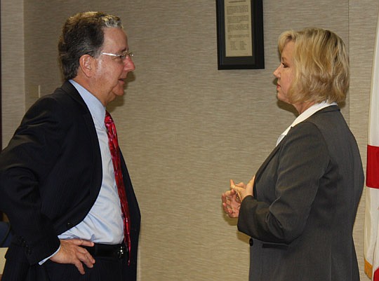 Photos by Joe Wilhelm Jr. - New JEA Managing Director/CEO Paul McElroy and JEA board member Lisa Strange Weatherby at the board's monthly meeting Tuesday. The board approved McElroy's three-year contract of $381,000 annually.