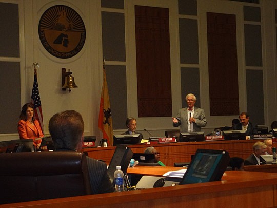 Photo by David Chapman - City Council Vice President Bill Gulliford discusses a budgetary item with Council members near the conclusion of Tuesday's meeting. Council unanimously approved the $945 million budget for fiscal 2012-13, which begins Monday.