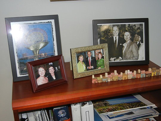 Photo by Karen Brune Mathis - Myrick displays special photographs, including the one at the lower left with the late Congresswoman
