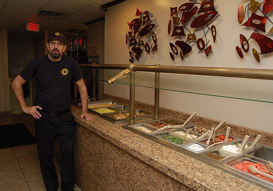 Photos by Max Marbut - Jerry Ewais, owner of Zodiac Bar &amp; Grill, with Downtown's popular Mediterranean lunch buffet.