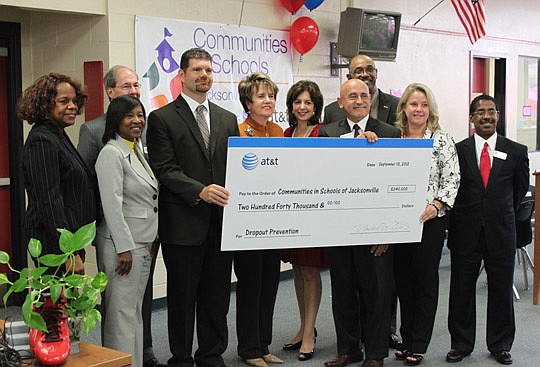 Representatives from Communities In Schools of Jacksonville accept a $240,000 grant from AT&amp;T Florida Regional Director for External Affairs Heather Duncan (second from right) to provide case management and student enrichment services for more tha...