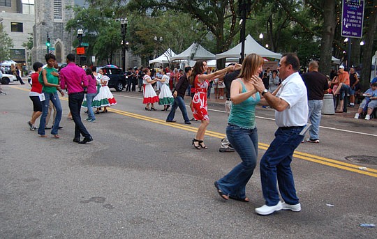 Photo by Max Marbut - Even with more rain than shine, thousands still turned out for the "Hispanic Heritage" edition of First Wednesday Art Walk.