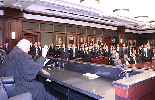 Photos by Joe Wilhelm Jr. - Fourth Circuit Chief Judge Donald Moran swears in about 100 new attorneys Sept. 27 at the Duval County Courthouse. It was the first swearing-in ceremony at the new courthouse.