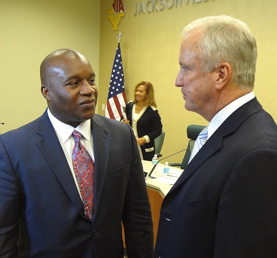 Photo by David Chapman - Nathaniel Ford (left) was selected by the Jacksonville Transportation Authority's board of directors to succeed Michael Blaylock as the authority's executive director and CEO. Ed Burr (right), JTA board chair, congratulates Fo...