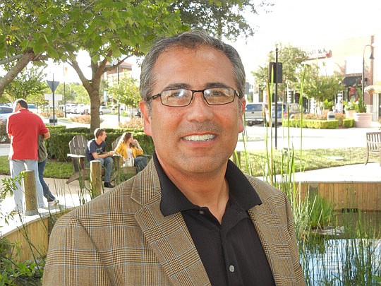 Photos by Karen Brune Mathis - Sal Saldana spends his days at the St. Johns Town Center. As the general manager, he starts each morning by walking the Southside open-air shopping center and keeping up with the progress of the shoppers, employees and m...