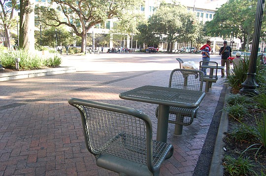 Photo by Max Marbut - If proposed legislation is enacted, the tables and chairs may be removed from Hemming Plaza. Playing card games also could be prohibited in Downtown's central public green space.