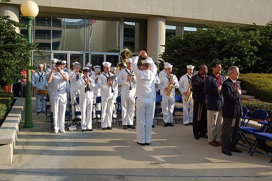 Photos by Max Marbut - The Navy Band Southeast performed "The Star-Spangled Banner" as the American flag was raised Wednesday morning at the JEA Building along Church Street. The event was part of the public utility's 5th Annual Military Appreciation Day.