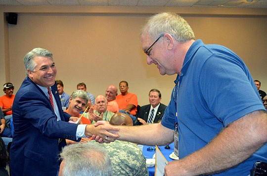 Jacksonville Port Authority CEO Paul Anderson on Monday shakes hands with veteran Tim Blanton, who is the assistant operations manager at the Talleyrand Marine Terminal, at the port's veterans appreciation event.
