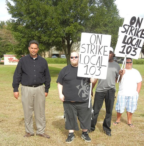 Photo by Karen Brune Mathis - Members of the Bakery, Confectionary, Tobacco Workers and Grain Millers International Union Local 103 hold picket signs at the Interstate Brands plant in North Jacksonville. The bakers' union is striking at Hostess Brands...