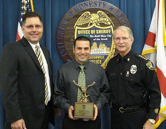 From left, Clear Channel Outdoor-Jacksonville Division President Brent Bolick and Vice President of Real Estate and Public Affairs Damien D'Anna with Sheriff John Rutherford. The Police Athletic League recognized the company for its donation of publi...