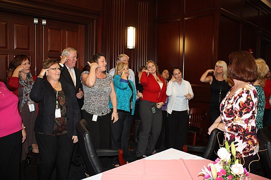 Photo by Joe Wilhelm Jr. - Chief Judge Donald Moran and 4th Circuit judicial assistants form a flash mob Dec. 3 to sing "Call Me Maybe" to retiring judicial assistants Linda Davis and Sandy Jackson as a way of saying keep in touch. The retirement rece...
