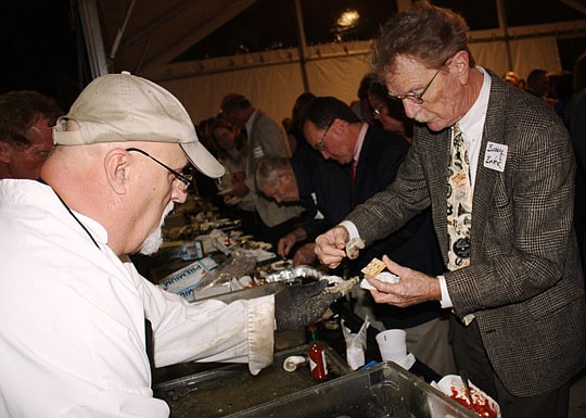 Photos by Joe Wilhelm Jr. - Attorney Barry Bobek partakes in the oyster bar.