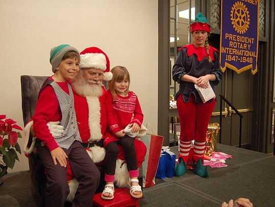 Photos by Max Marbut - John Thomas and Samantha Diamond had a short conference Monday with Santa Claus at the Omni Hotel during the Rotary Club of Jacksonville meeting.