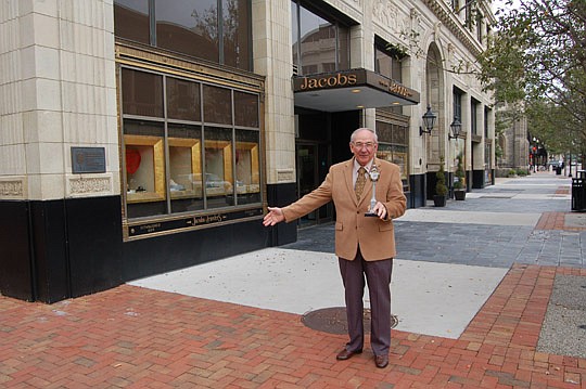 Photo by Max Marbut - When Jacobs Jewelers owner Roy Thomas wants to see the historic clock in front of his store along Laura Street, he steps out to the sidewalk with a miniature replica of the iconic Downtown timepiece.