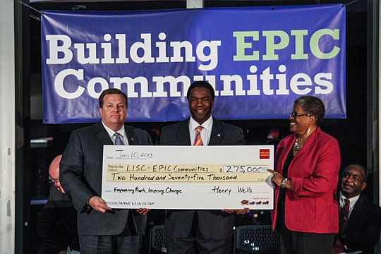 From left, Scott Coble, North Florida regional president for Wells Fargo, and Mayor Alvin Brown presented a check Jan. 10 to Janet Owens, executive director for LISC Jacksonville. The grant is part of Wells Fargo's NeighborhoodLIFT program, which stab...