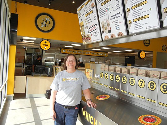 Photo by Karen Brune Mathis - Jean Volk and her husband and son will open Which Wich to the public Friday. The shop is near Tinseltown in Southside. She stands at the counter where customers can custom-order their sandwiches by marking bags to show th...