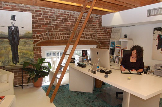 Tiffany Manning in her photography studio office Downtown at 220 E. Forsyth St. The ladder provides her access to the building's roof.